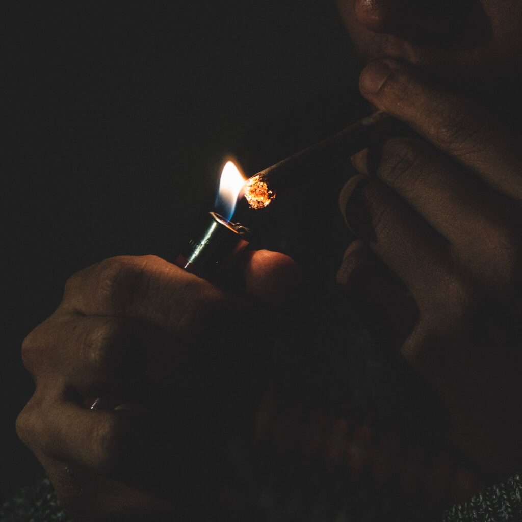lit blunt with smoke in the background
