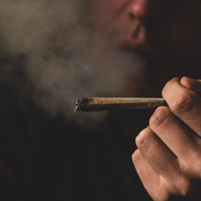 lit blunt with smoke in the background