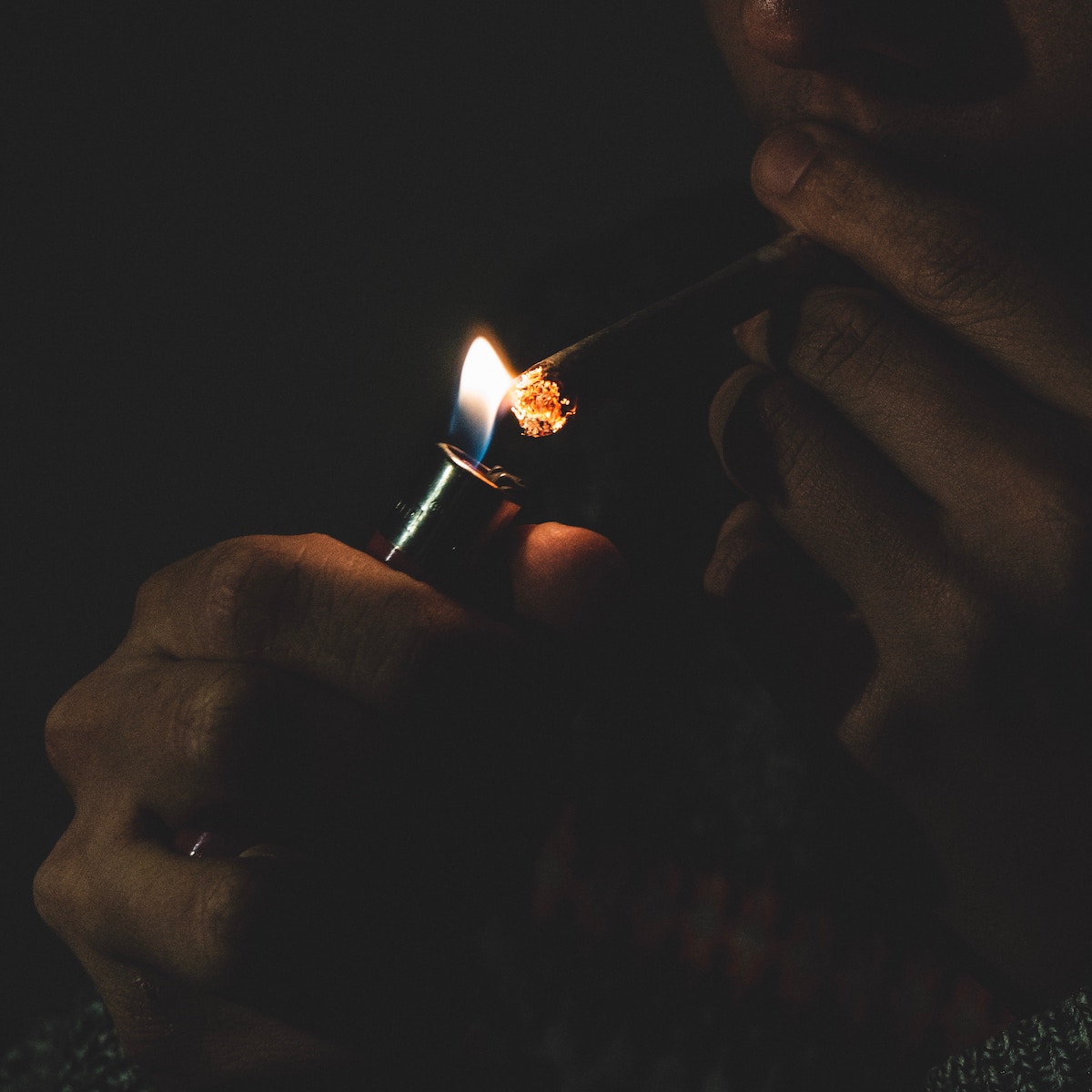 lit blunt with smoke in the background