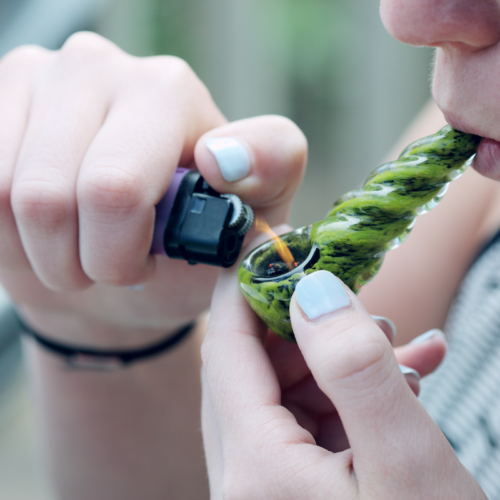 Lighting weed in a pipe to smoke